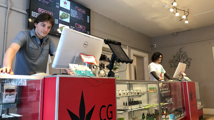 In this Wednesday, March 6, 2019 photo, Korbin Osborn, left, works as a cannabis adviser at a medical marijuana dispensary in Santa Fe, N.M.