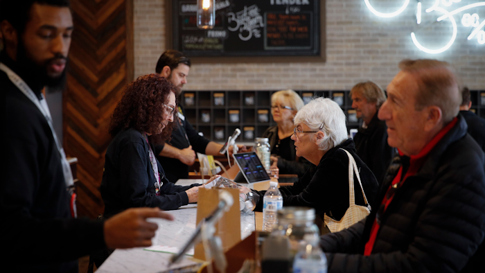 In this Feb. 19, 2019, photo, a group of seniors from Laguna Woods Village consult with sales associates at Bud and Bloom cannabis dispensary in Santa Ana, Calif.