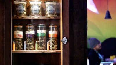 In this photo taken Thursday, March 28, 2019, marijuana products line a locked cabinet at a marijuana shop in Seattle.