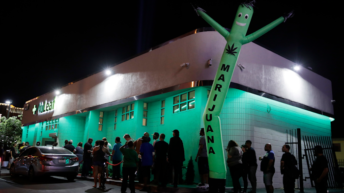 In this July 1, 2017, file photo, people line up at the NuLeaf marijuana dispensary in Las Vegas.