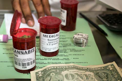 In this May 14, 2013, file photo, medical marijuana prescription vials are filled at a medical marijuana dispensary in Los Angeles.