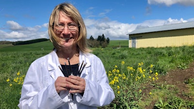 In this April 12, 2019, photo, Cyndi Michael, a former medical marijuana grower, holds the last syringes of cannabis tincture she will process for sale in Rickreall, Ore., after deciding to no longer grow medical marijuana.