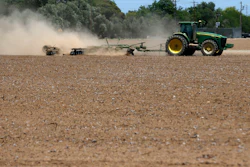 In this May 23, 2018, file photo, a farmer plows a dry and dusty cotton field in Phoenix.