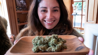 In this Thursday, June 20, 2019, photo, Christy Banda, a representative for the Jack Herer cannabis company, displays their latest marijuana flower during WeedCon West in Los Angeles.