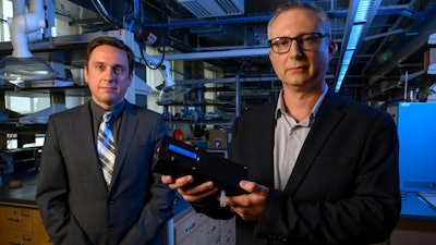 Ervin Sejdic, PhD (left) and Alexander Star, PhD, hold up the prototype of their THC-detecting device.