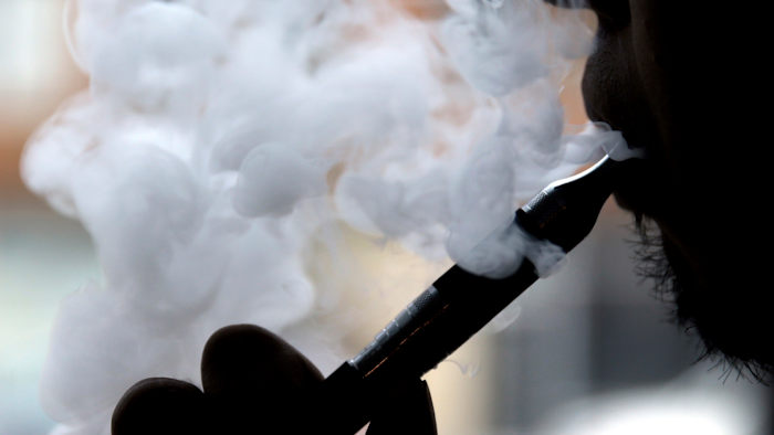 In this April 23, 2014, file photo, a man smokes an electronic cigarette in Chicago.