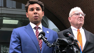 Fall River Mayor Jasiel Correia speaks beside his attorney, Kevin Reddington, outside the federal courthouse in Boston, Friday, Sept. 6, 2019.