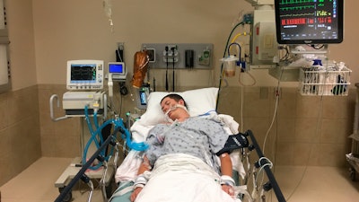 This May 2018 photo, provided by Joseph Jenkins, shows his son, Jay, in the emergency room of the Lexington Medical Center in Lexington, S.C.