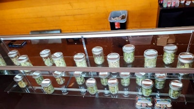 This Dec,. 12, 2019, photo shows a display with jars of marijuana at Save Greens Cannabis dispensary in Los Angeles.