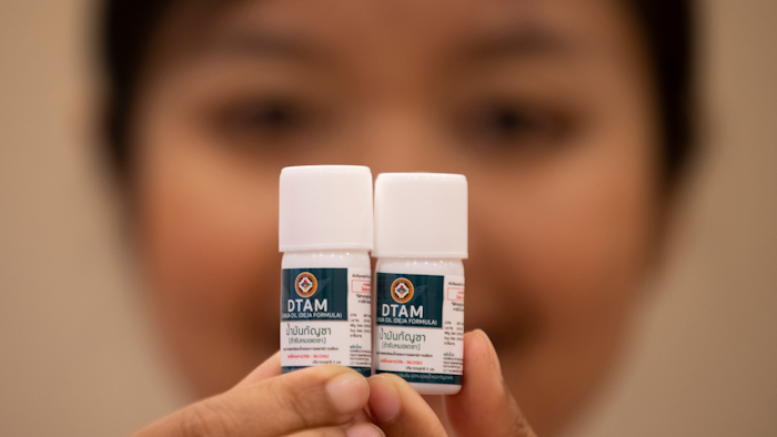 A doctor shows containers of cannabis oil at a clinic in Nonthaburi province, Thailand, Jan. 6, 2020.