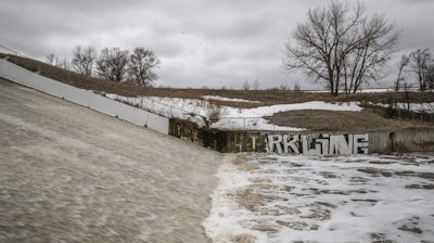 Water flows over the spillway at White Clay Dam near Pine Ridge, S.D., following spring flooding, March 25, 2019.