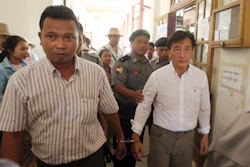 Shein Latt, left, leaves a local court after being arrested for operating a marijuana plantation in Ngazun Township, Myanmar, May 7, 2019.