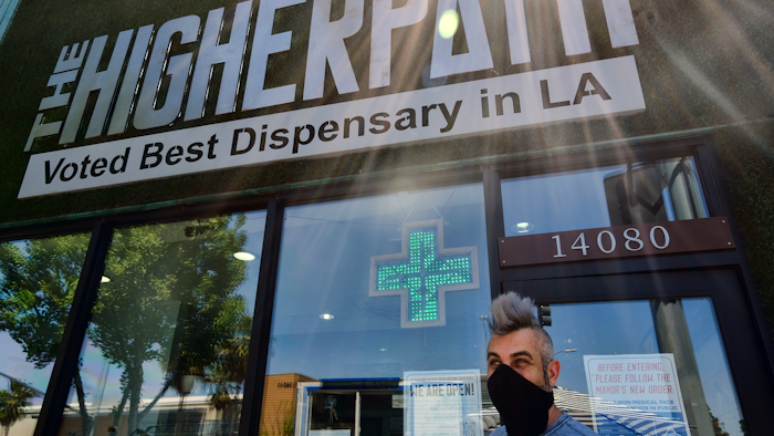 Owner Jerred Kiloh stands outside The Higher Path cannabis dispensary in Los Angeles, April 16, 2020.