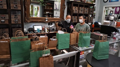 Budtenders prepare orders at The Higher Path cannabis dispensary, Sherman Oaks, Los Angeles, April 16, 2020.