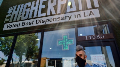 Owner Jerred Kiloh stands outside The Higher Path cannabis dispensary in Los Angeles, April 16, 2020.