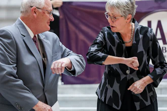 Utah Republican gubernatorial candidate Jan Garbett, right, elbow-bumps Dr. Joseph Jarvis as she introduces him as her running mate at the state Capitol in Salt Lake City, March 19, 2020.