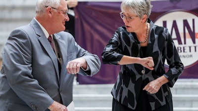 Utah Republican gubernatorial candidate Jan Garbett, right, elbow-bumps Dr. Joseph Jarvis as she introduces him as her running mate at the state Capitol in Salt Lake City, March 19, 2020.