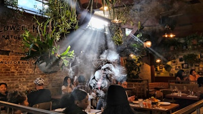 Budtenders wearing protective masks prepare orders for customers at the Higher Path dispensary, Sherman Oaks, Los Angeles, April 16, 2020.