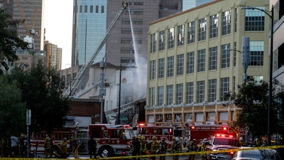 Firefighters work the scene of a structure fire in Los Angeles, May 16, 2020.