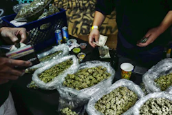 A vendor makes change for a customer at a cannabis marketplace in Los Angeles, April 15, 2019.