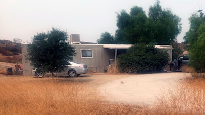 A car is left parked at a house where killings occurred in the rural town of Aguanga, Calif., Sept. 8, 2020.