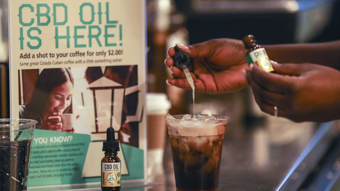 A worker adds CBD oil to a drink at a coffee shop in Fort Lauderdale, Fla., Jan. 4, 2018.