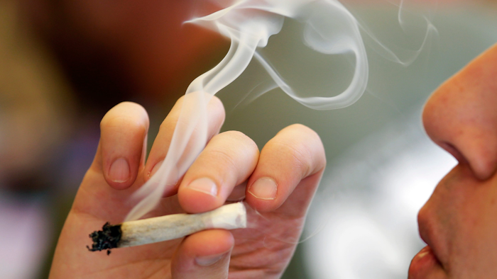 A man smokes a marijuana joint in Seattle, April 20, 2016.