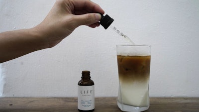 An employee adds drops of cannabidiol to a coffee glass at the Found Cafe, Hong Kong, Sept. 13, 2020.