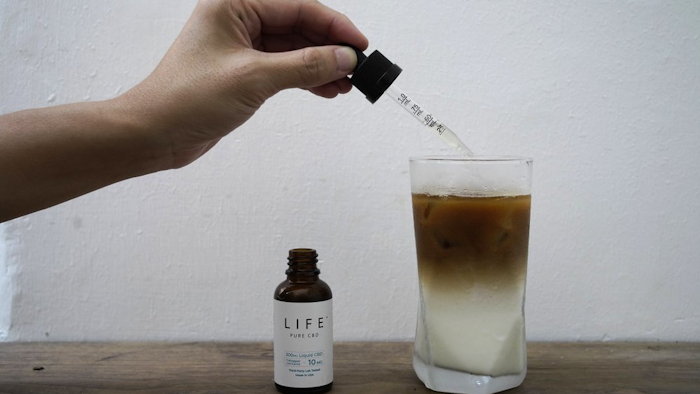An employee adds drops of cannabidiol to a coffee glass at the Found Cafe, Hong Kong, Sept. 13, 2020.