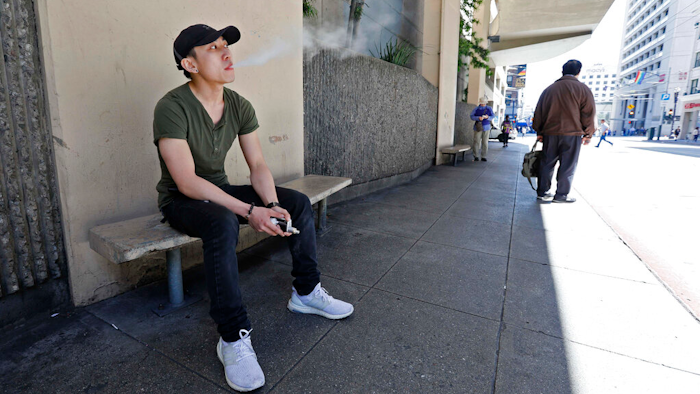 Jacky Chan takes a break from his job at a smoke shop in San Francisco, June 17, 2019.