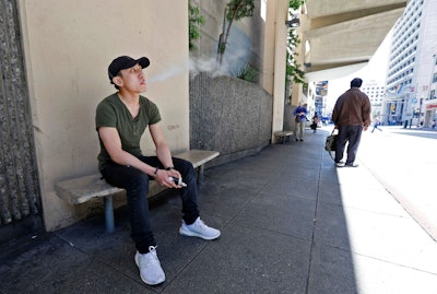 Jacky Chan takes a break from his job at a smoke shop in San Francisco, June 17, 2019.