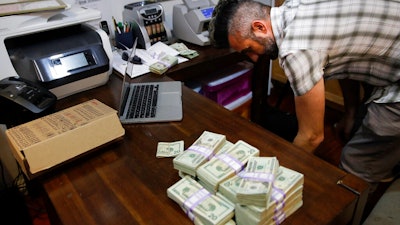 Jerred Kiloh, owner of Higher Path medical marijuana dispensary, preparing to pay his monthly tax payment in cash, Los Angeles, June 27, 2017.