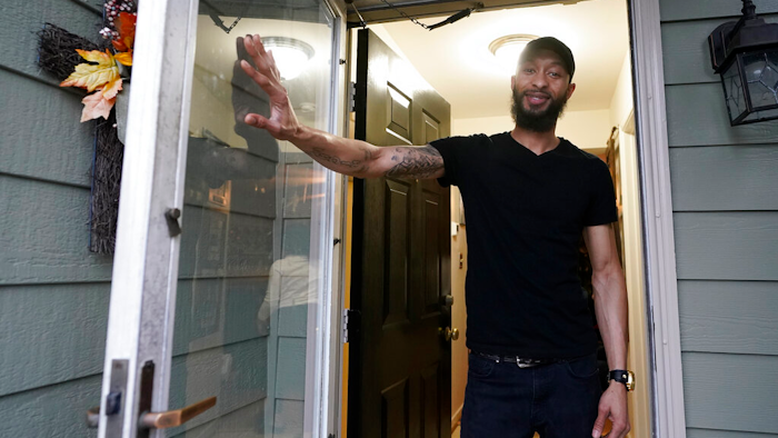 Richard Coleman II poses in his home in Richmond, Va., Feb. 11, 2021.