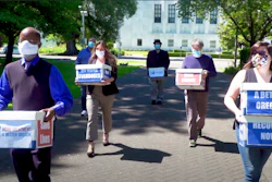 Volunteers deliver boxes containing signed petitions to the Oregon Secretary of State's office in Salem, June 26, 2020.