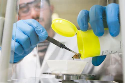 A laboratory technician weighs cannabis flower for testing at MCR Labs.