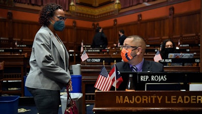 Connecticut House Majority Leader Jason Rojas, D-East Hartford, speaks with Rep. Toni Walker, D-New Haven, during session at the State Capitol in Hartford, April 19, 2021.