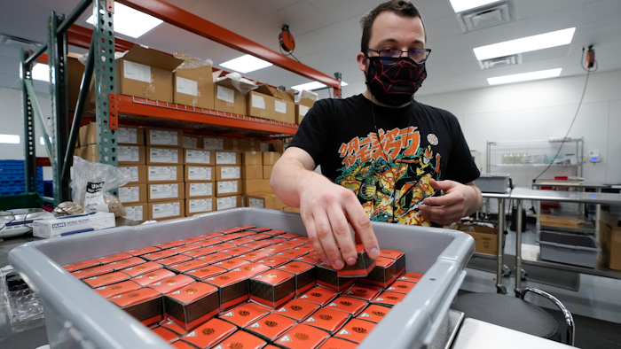 Bill Mathis packages THC products in Hazel Park, Mich., April 29, 2021.