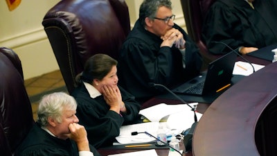 Mississippi Supreme Court Associate Justices T. Kenneth Griffis, left, Dawn Beam, center, and Josiah Dennis Coleman during arguments over a medical marijuana initiative, Jackson, April 14, 2021.