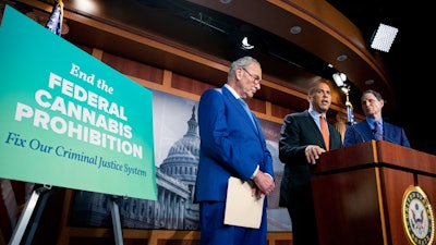 From left, Senate Majority Leader Chuck Schumer, D-N.Y., Sen. Cory Booker, D-N.J., and Sen. Ron Wyden, D-Ore., announce a draft bill that would decriminalize marijuana on Capitol Hill, July 14, 2021.