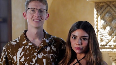 William Goodall, and Katiana Kay, his partner in their CBD online shop Bay Smokes, pose for a photo, Thursday, July 22, 2021, in Sunny Isles Beach, Fla. The two began selling delta-8 products in December with delta-8 quickly becoming a main source of revenue. The chemical, called delta-8 THC, is billed as producing a milder high than the better known delta-9 THC, and delta-8 is often marketed as being legal even where marijuana is not.