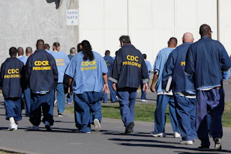 Inmates walk through the exercise yard at California State Prison Sacramento, near Folsom, Calif., Feb. 26, 2013.
