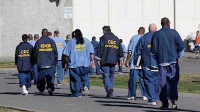 Inmates walk through the exercise yard at California State Prison Sacramento, near Folsom, Calif., Feb. 26, 2013.