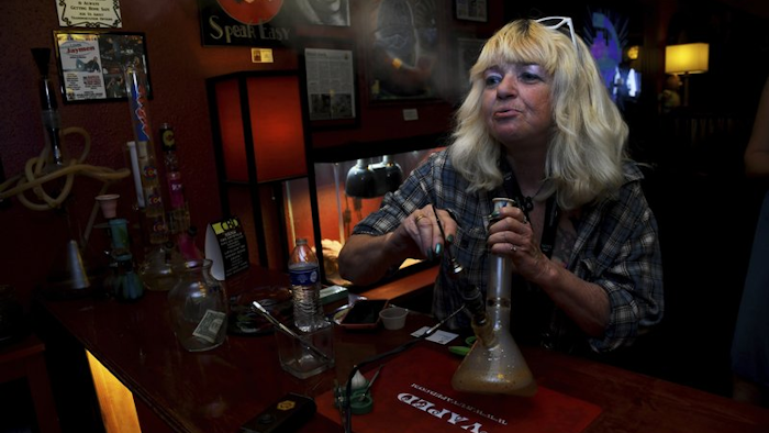 Linda Wood smokes a dab at the Speakeasy Vape Lounge, Colorado Springs, Colo., April 12, 2017.
