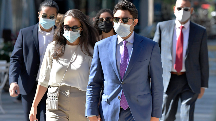 Former Fall River, Mass., Mayor Jasiel Correia, right, arrives with his wife Jenny Fernandes and family members for a court appearance, Boston, Sept. 20, 2021.