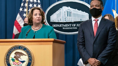 Deputy Attorney General Lisa Monaco, with Assistant Attorney General Kenneth Polite Jr., during a news at the Department of Justice in Washington, Oct. 26, 2021.