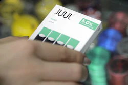 A woman buys refills for her Juul at a smoke shop in New York, Dec. 20, 2018.
