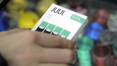 A woman buys refills for her Juul at a smoke shop in New York, Dec. 20, 2018.