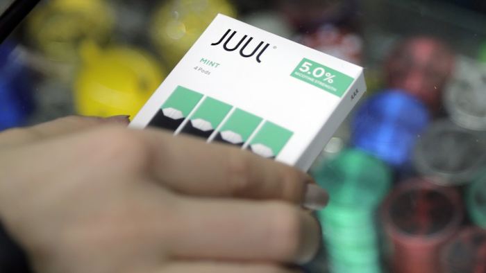 A woman buys refills for her Juul at a smoke shop in New York, Dec. 20, 2018.