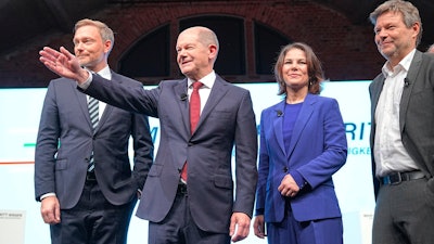 From left, Christian Lindner, party leader of the FDP, Olaf Scholz, SPD candidate for chancellor, Annalena Baerbock, federal leader of the Green party, and Robert Habeck, federal leader of the Green party, at a joint news conference in Berlin, Nov. 24, 2021.