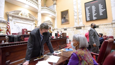 Maryland state Sen. Ron Young, left, D-Frederick County, talks with state Sen. Delores Kelley, D-Baltimore County, before the start of Maryland's 90-day legislative session, Jan. 12, 2022, Annapolis.